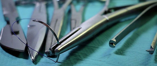 metal surgical instruments on a sterile blue fabric